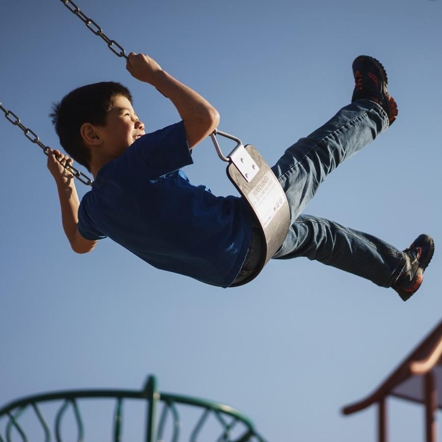 Close to the center of everything a boy on a swing